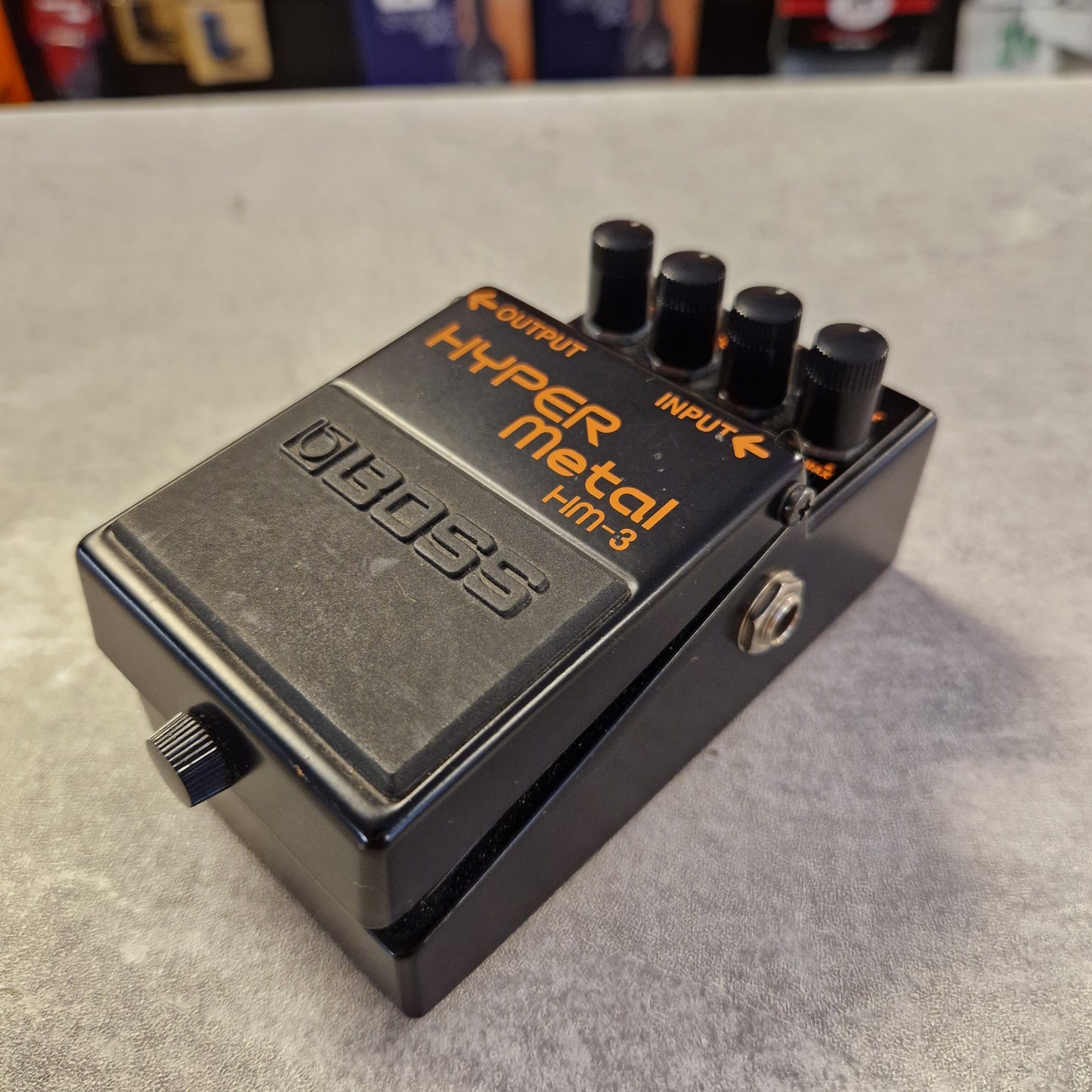 Pre-Owned Boss HM-3 Boss Hyper Metal HT-2 guitar effects pedal on a gray surface