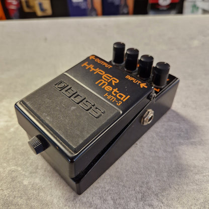 Pre-Owned Boss HM-3 Boss Hyper Metal HT-2 guitar effects pedal on a gray surface