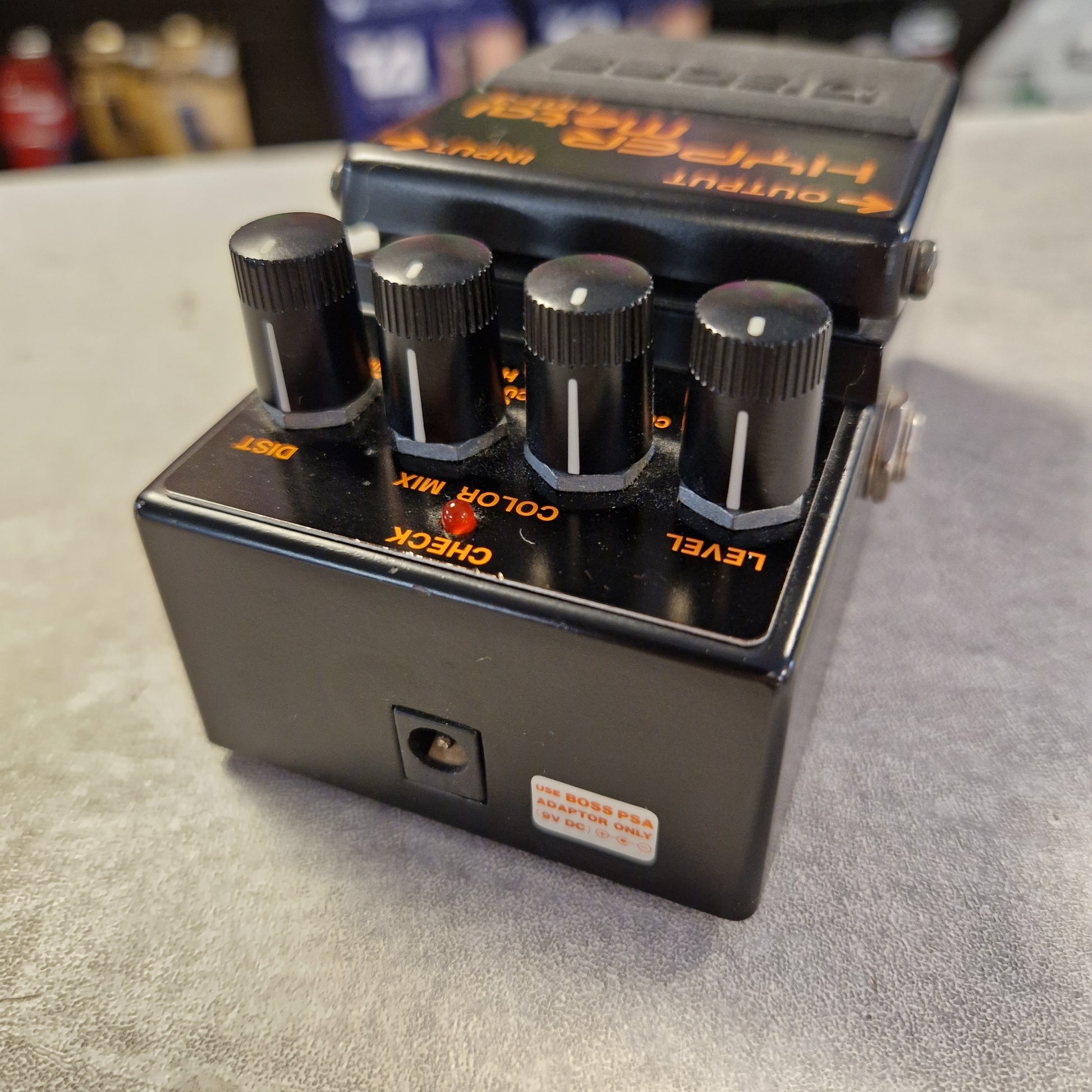 Pre-Owned Boss HM-3 Guitar effects pedal with three knobs on a textured surface