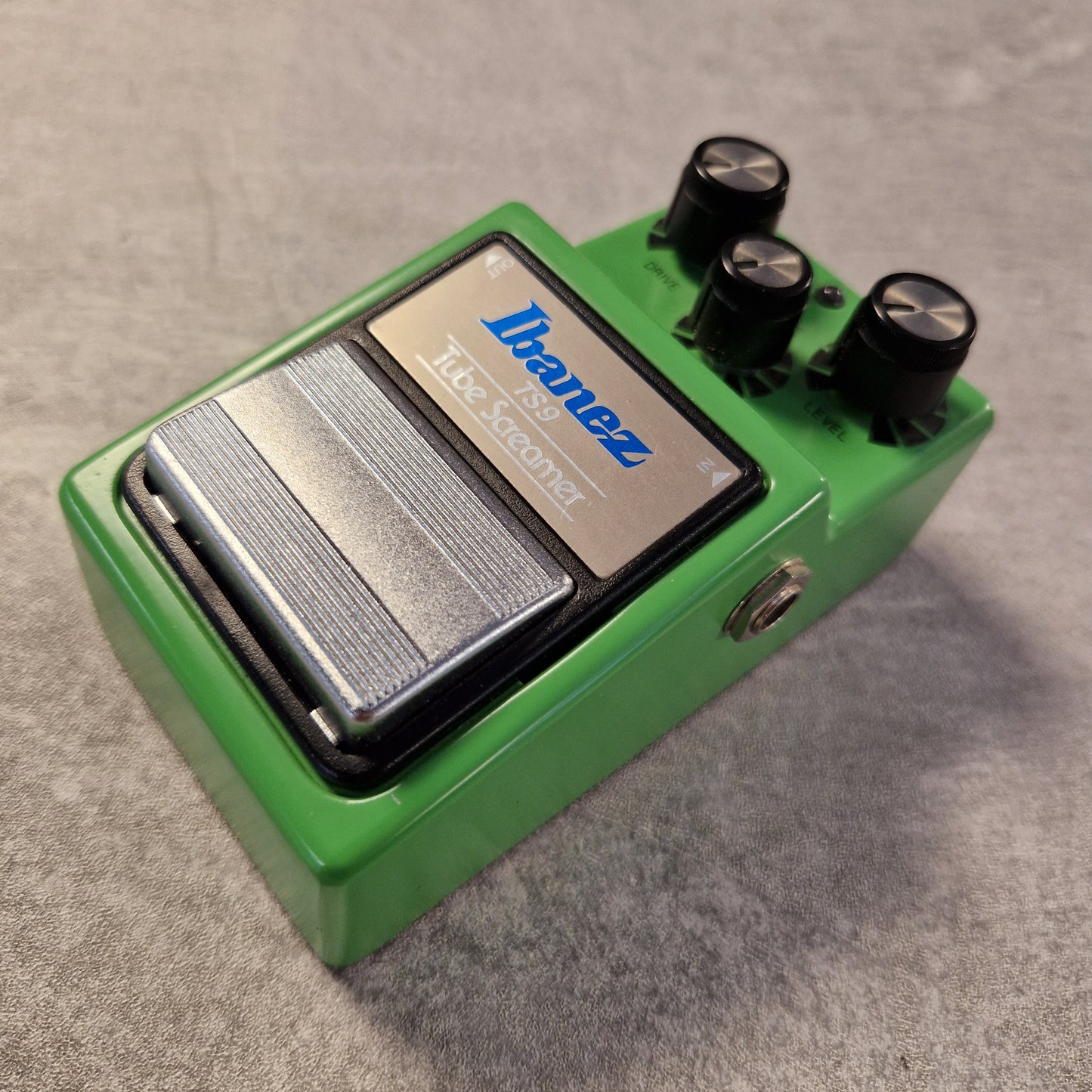 Pre-Owned Ibanez TS9 Green Ibanez guitar effects pedal on a gray surface