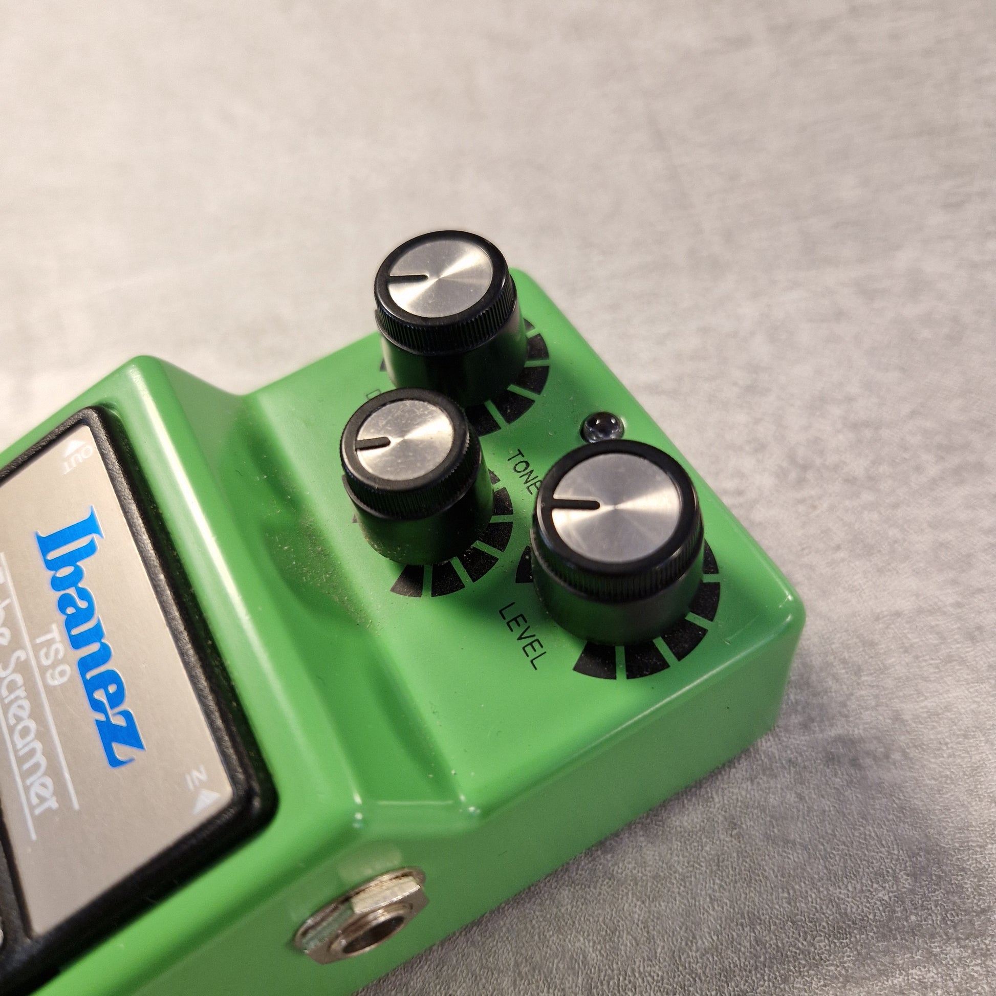 Pre-Owned Ibanez TS9 Green Ibanez guitar effects pedal with three knobs on a gray background