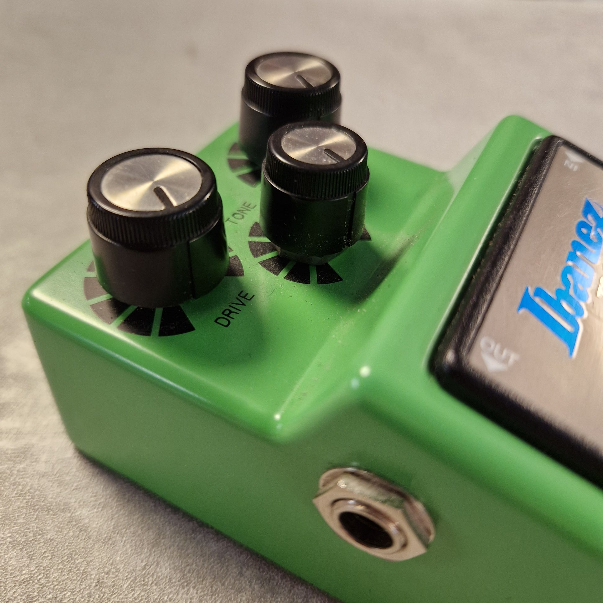 Pre-Owned Ibanez TS9 Green guitar effects pedal with two knobs and a label on a gray background