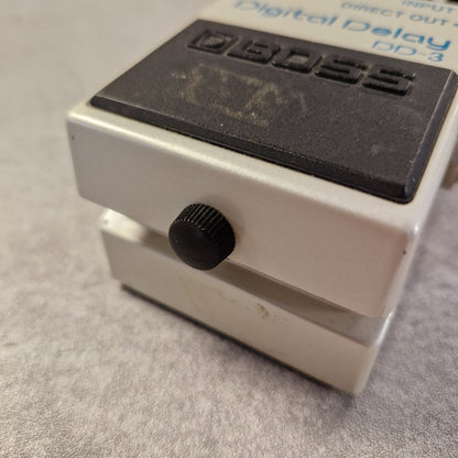 Pre-Owned Boss DD-3 Boss digital delay effect pedal on a gray surface