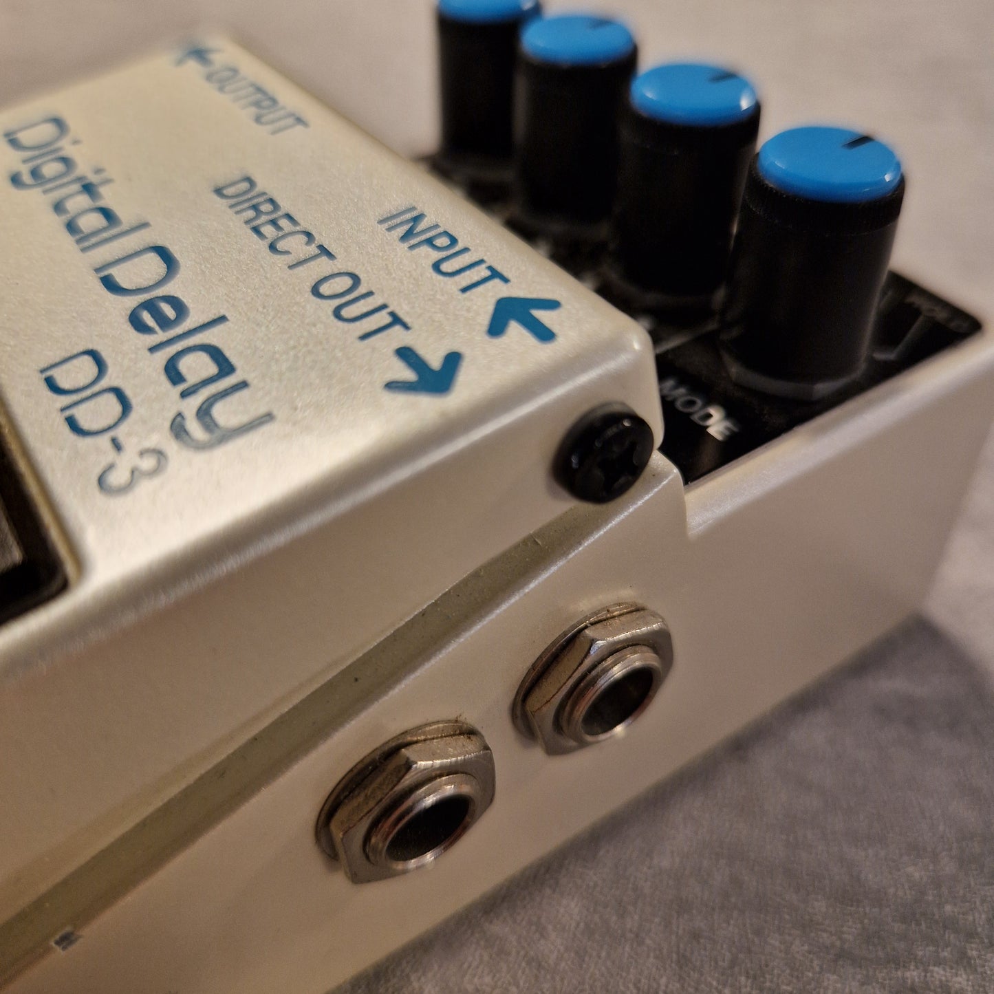 Pre-Owned Boss DD-3 Close-up of a digital delay effect pedal with labeled ports.