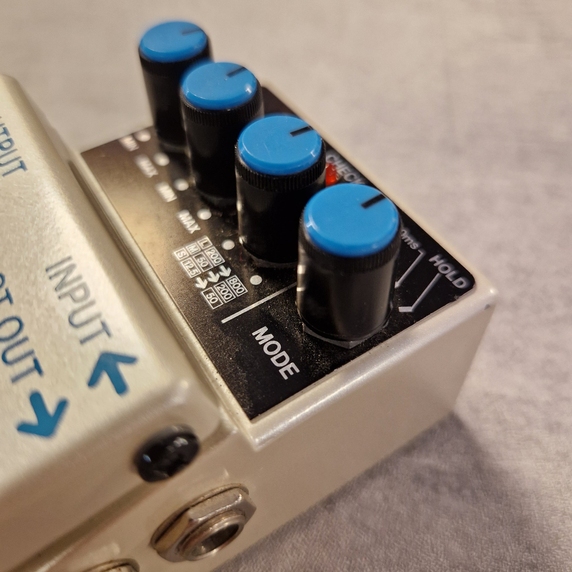 Pre-Owned Boss DD-3 Guitar effects pedal with blue knobs and labeled inputs and outputs.