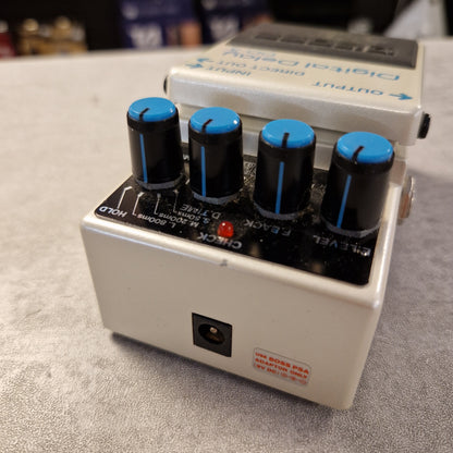 Pre-Owned Boss DD-3 Guitar effects pedal with blue knobs on a gray surface