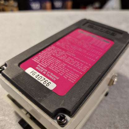 Pre-Owned Boss DD-3 Close-up of a Roland electronic device with a pink label on a blurred background