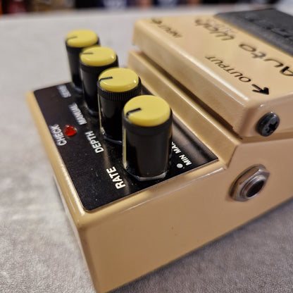 Pre-Owned Boss AW-2 Close-up of a guitar effects pedal with knobs and labels on a textured surface