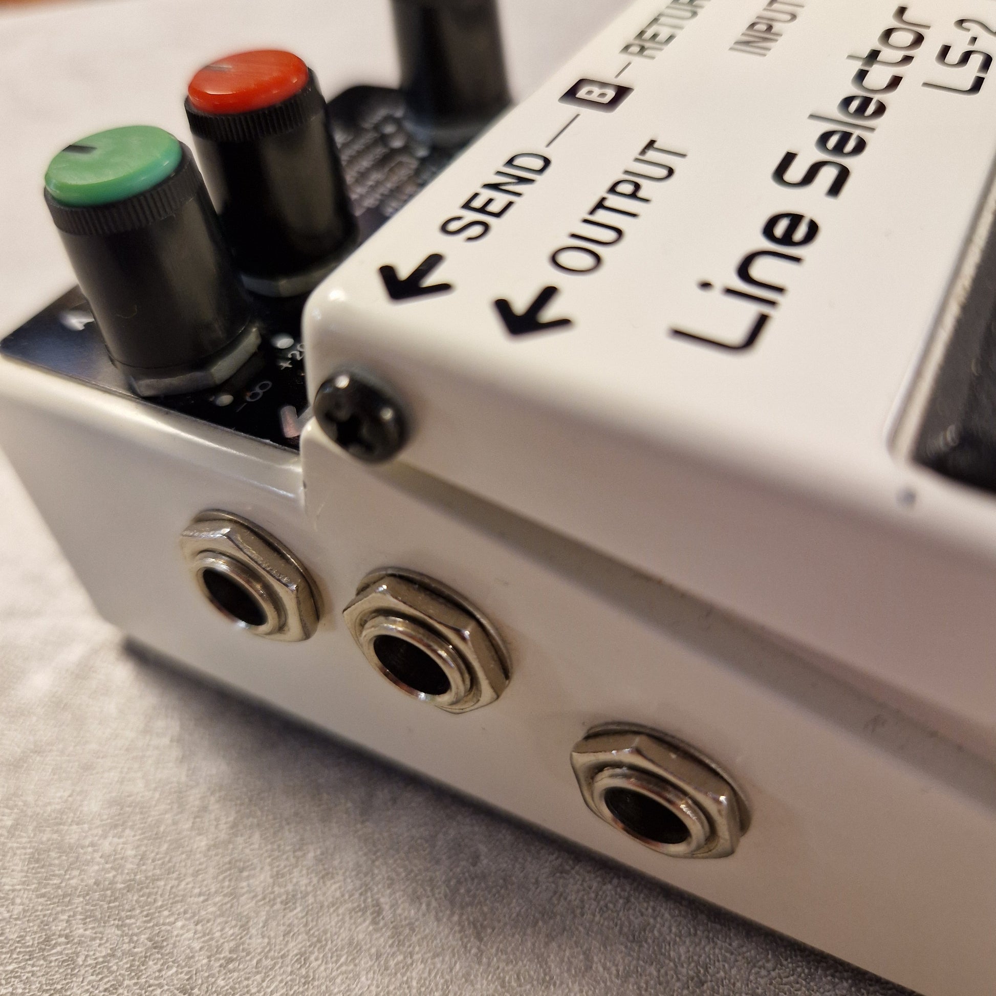 Pre-Owned Boss LS-2 Close-up of a Line Selector audio device with knobs and ports.