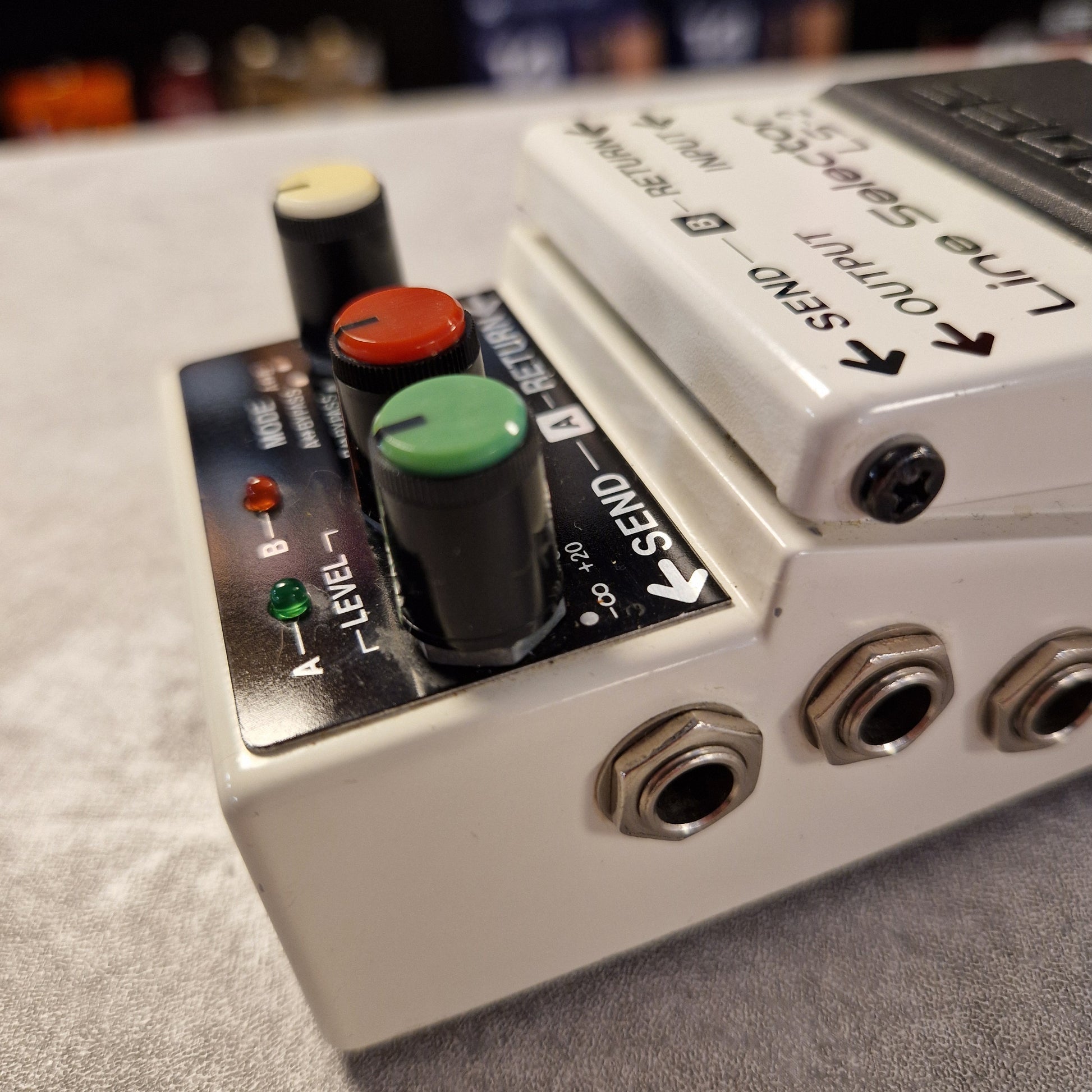 Pre-Owned Boss LS-2 Guitar effects pedal with control knobs and input/output jacks on a gray surface.