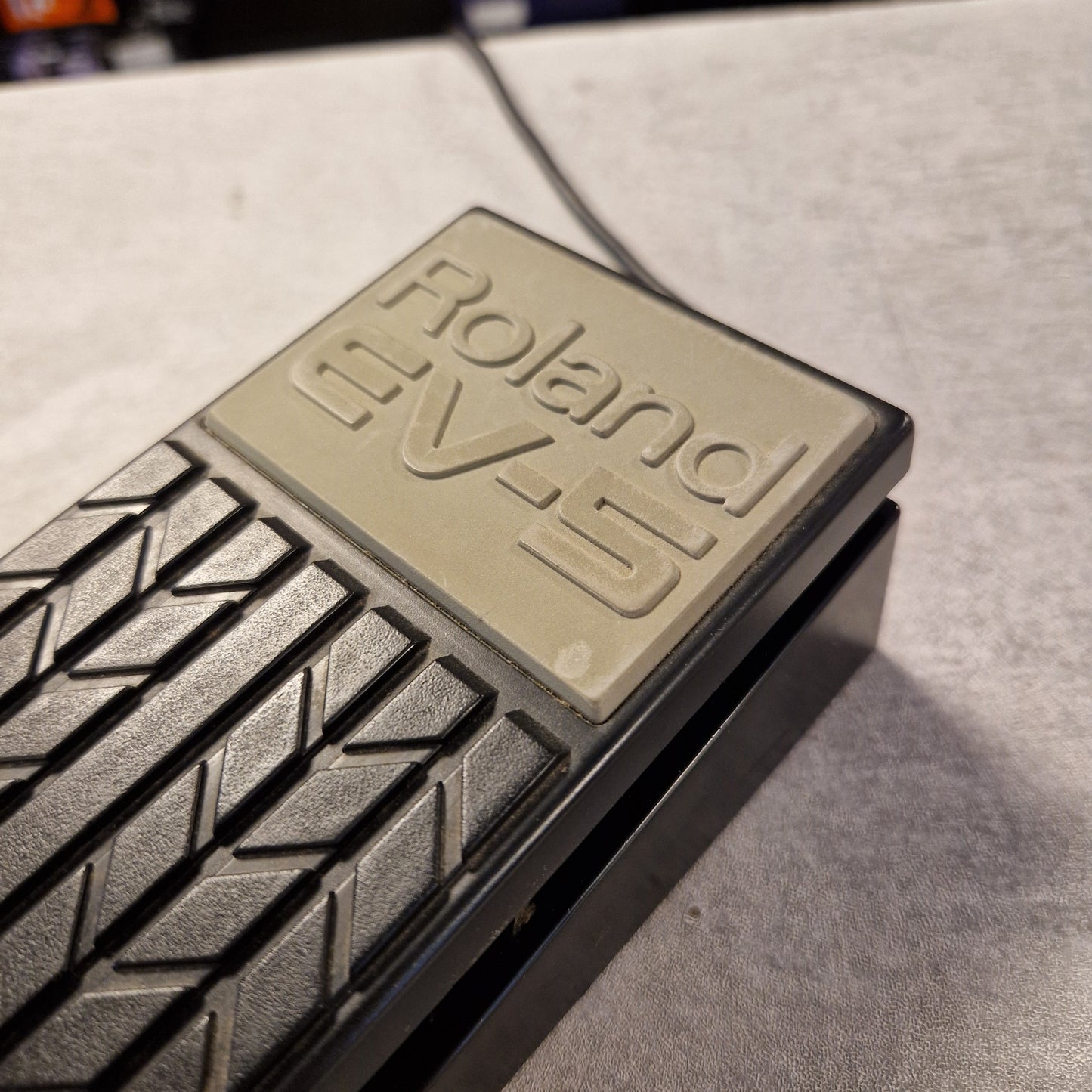 Pre-Owned Roland EV-5 Roland EV-10 electronic keyboard pedal on a gray surface