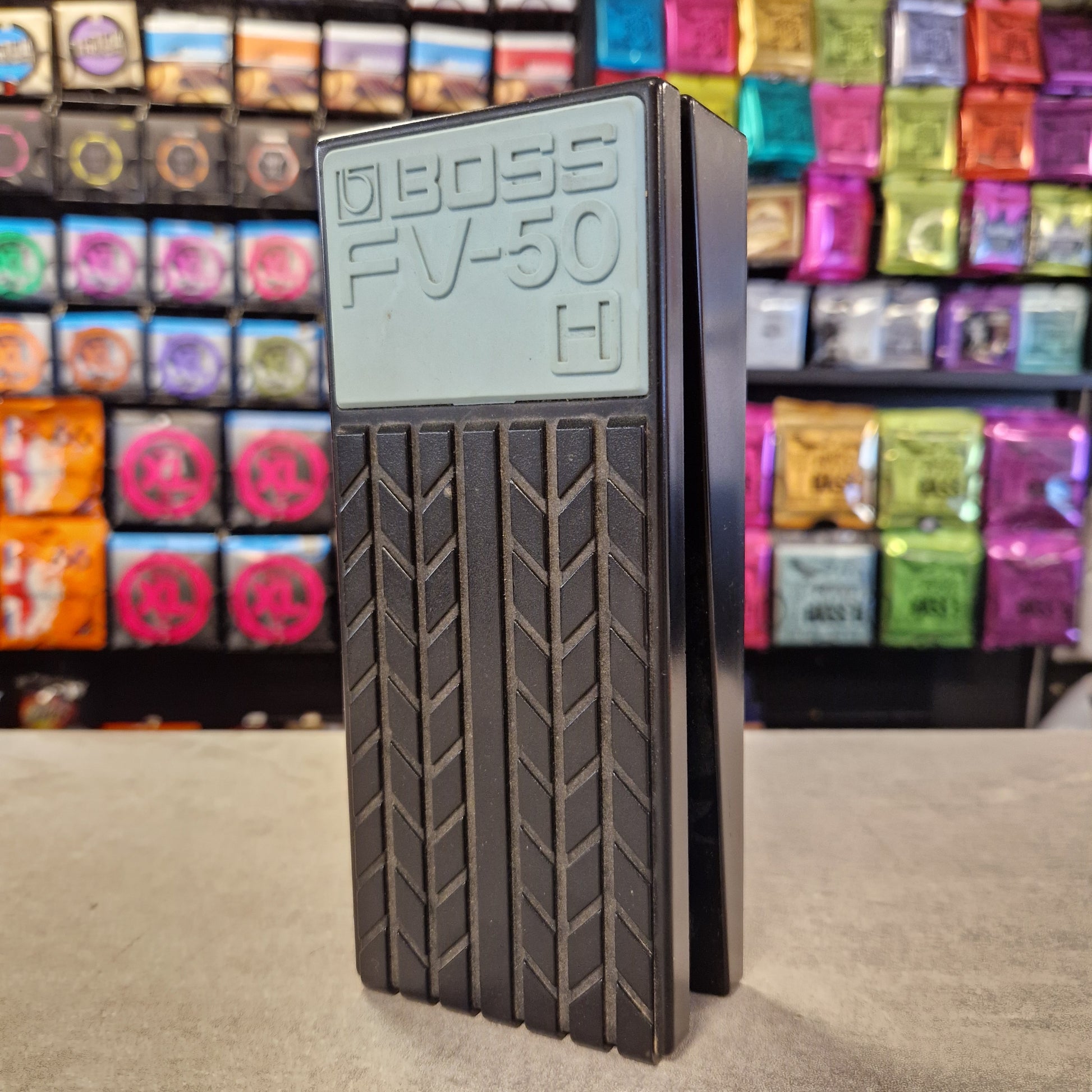 Pre-Owned Boss FV-50H Black rectangular object with 'BOSS FV50' branding against a colorful background