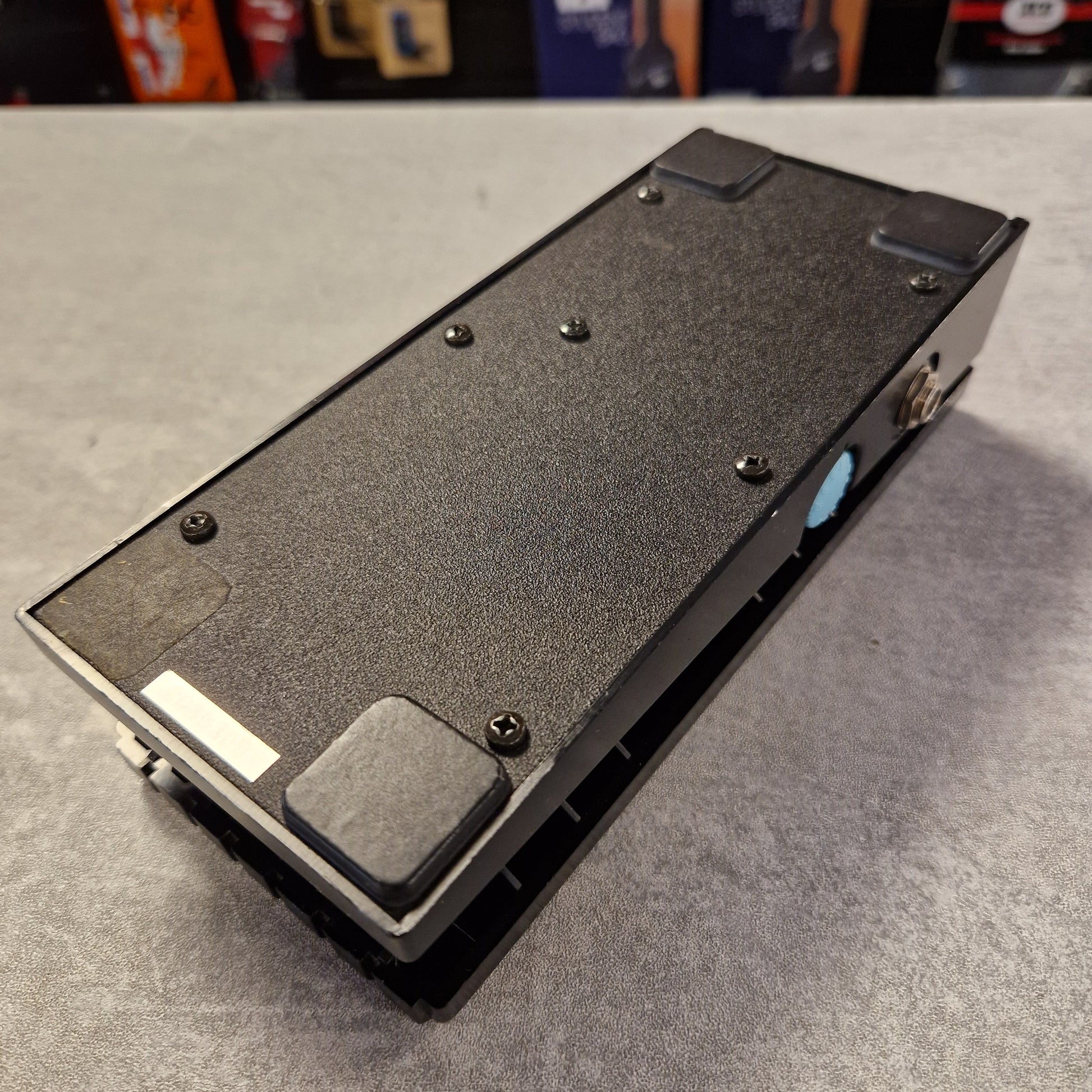 Pre-Owned Boss FV-50H Black electronic device on a gray surface with blurred background