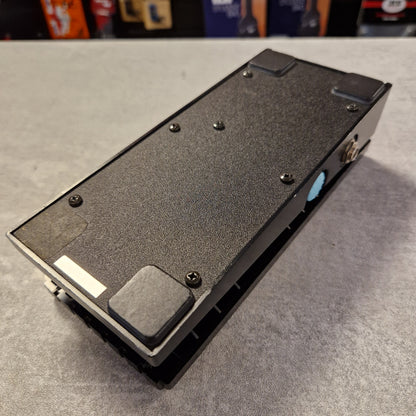 Pre-Owned Boss FV-50H Black electronic device on a gray surface with blurred background