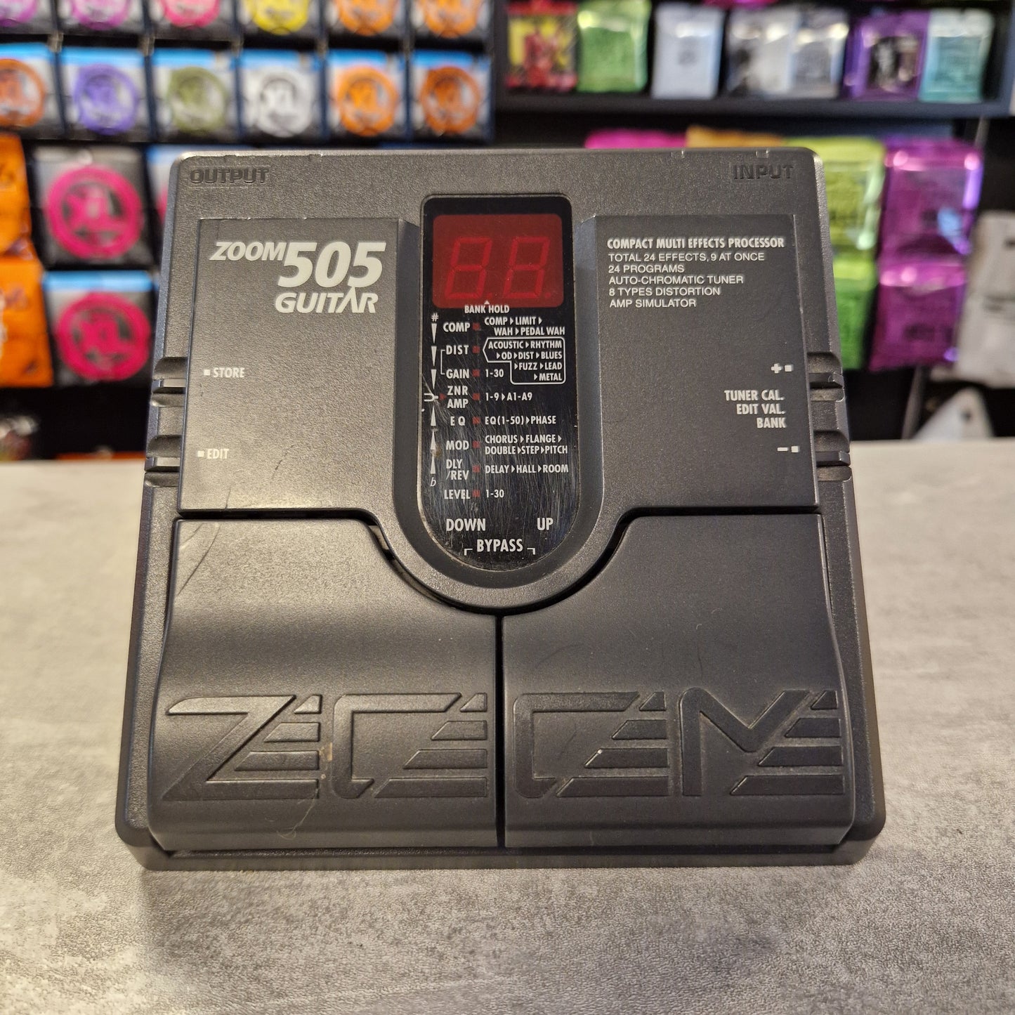 Pre-Owned Zoom 505 Guitar effects processor with digital display on a concrete surface