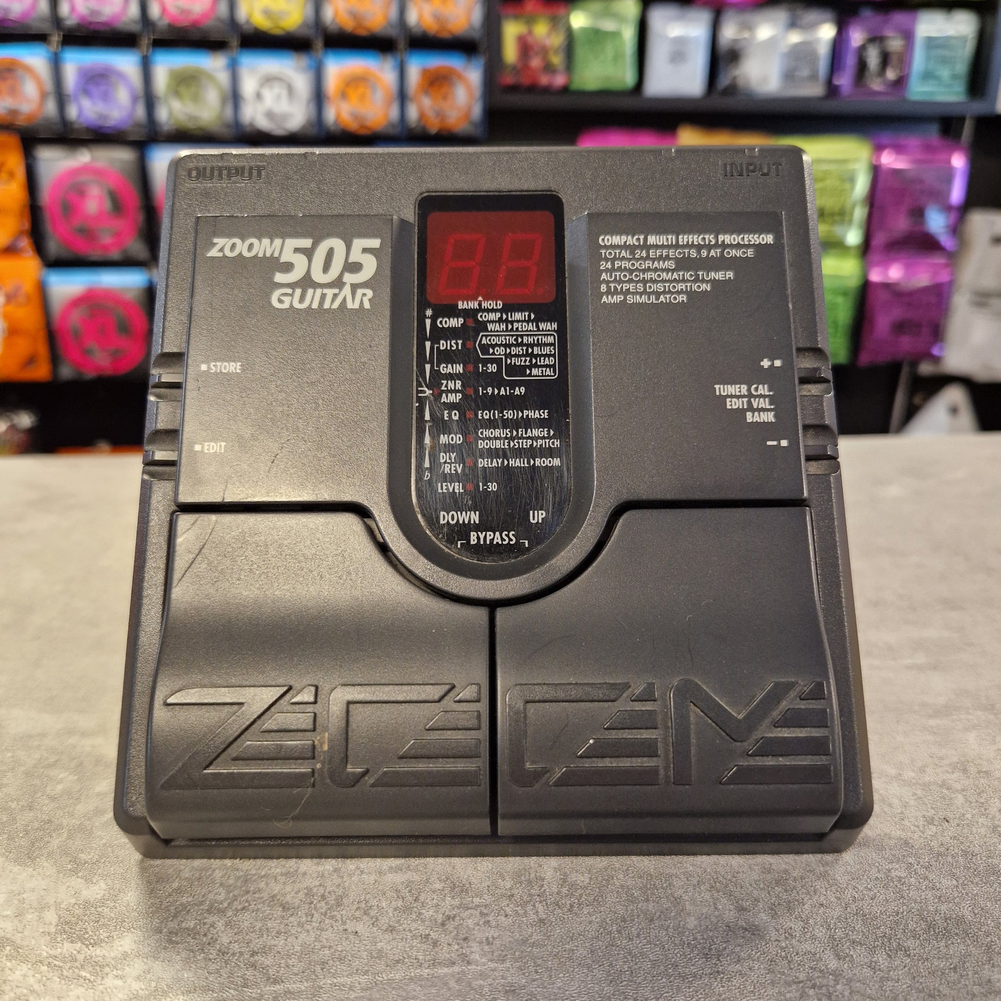 Pre-Owned Zoom 505 Guitar effects processor with digital display on a concrete surface