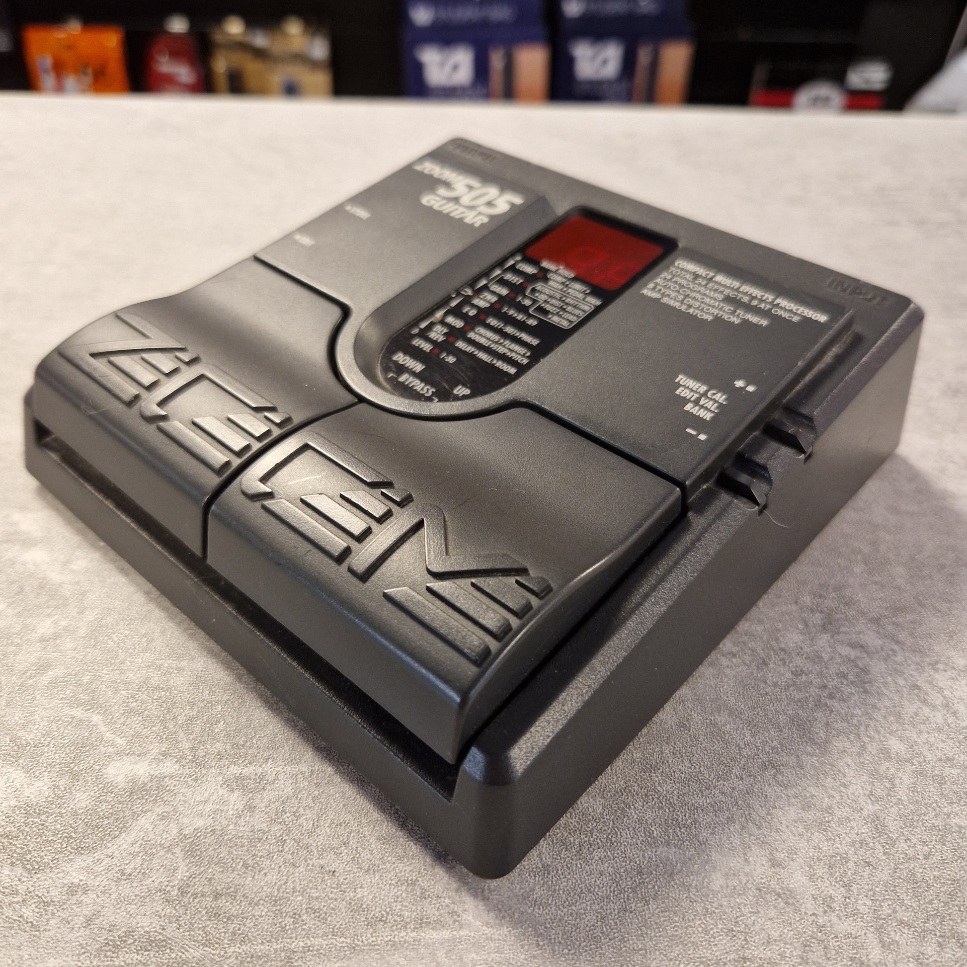 Pre-Owned Zoom 505 Black electronic device with text on a gray surface