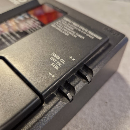 Pre-Owned Zoom 505 Close-up of a black electronic device with text and buttons on a gray surface