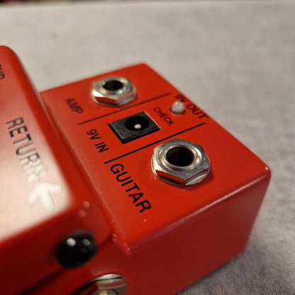 Pre-Owned Boss PSM-5  Close-up of a red guitar effects pedal with electrical connections.