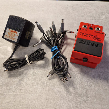 Pre-Owned Boss PSM-5 Red BOSS guitar pedal with power adapter and cables on a gray surface