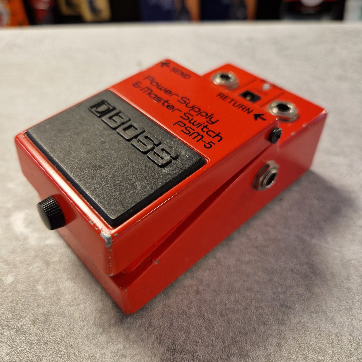 Pre-Owned Boss PSM-5 Red Boss guitar pedal on a gray surface