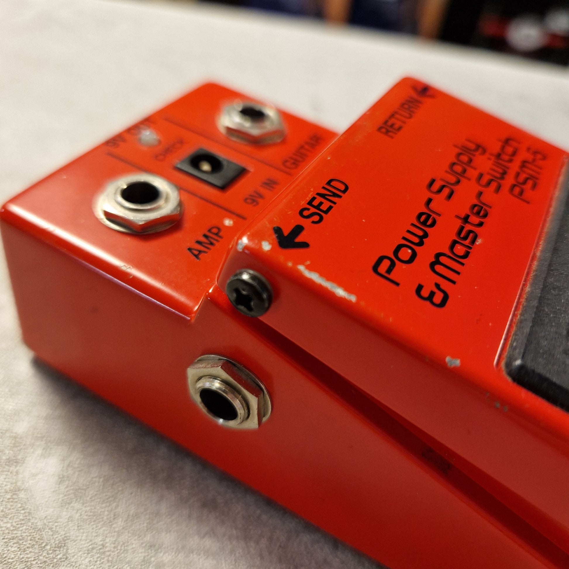 Pre-Owned Boss PSM-5 Red guitar effects pedal with visible brand name on a textured surface