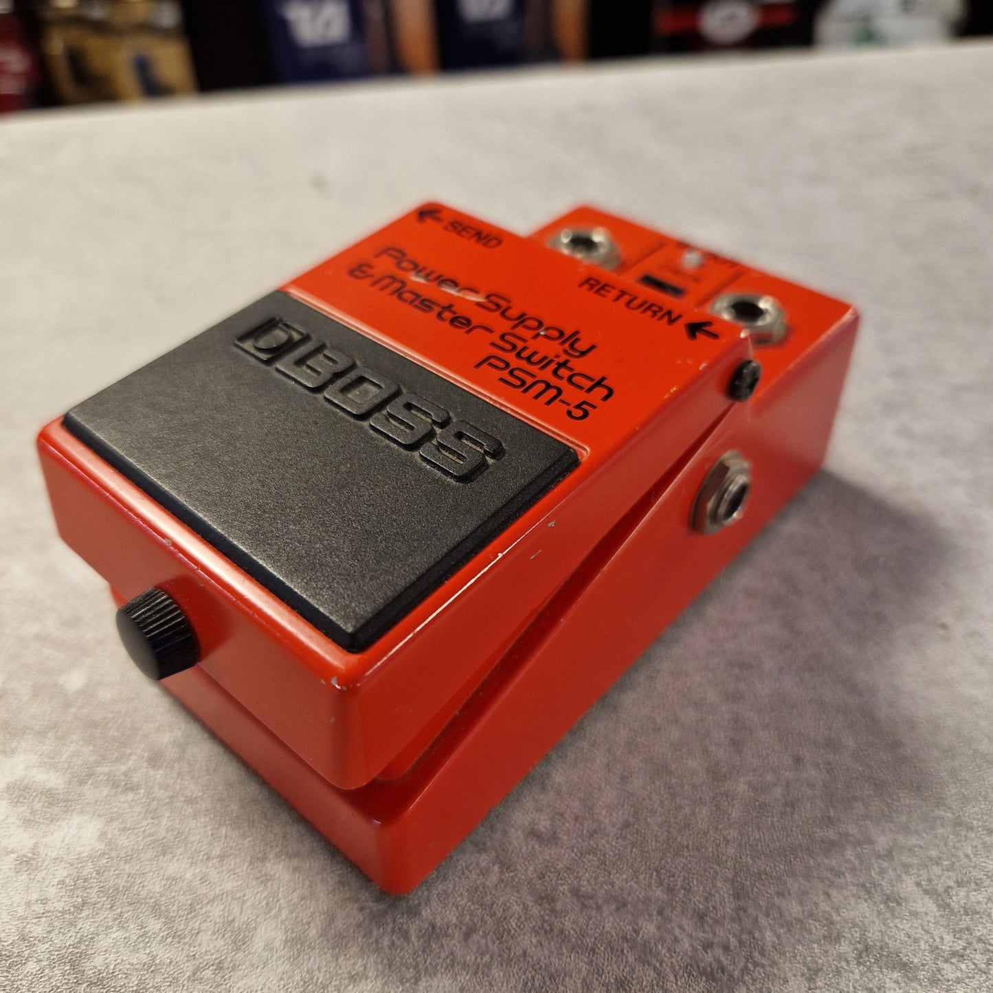 Pre-Owned Boss PSM-5 Red guitar effects pedal with 'Dunlop' branding on a gray surface.