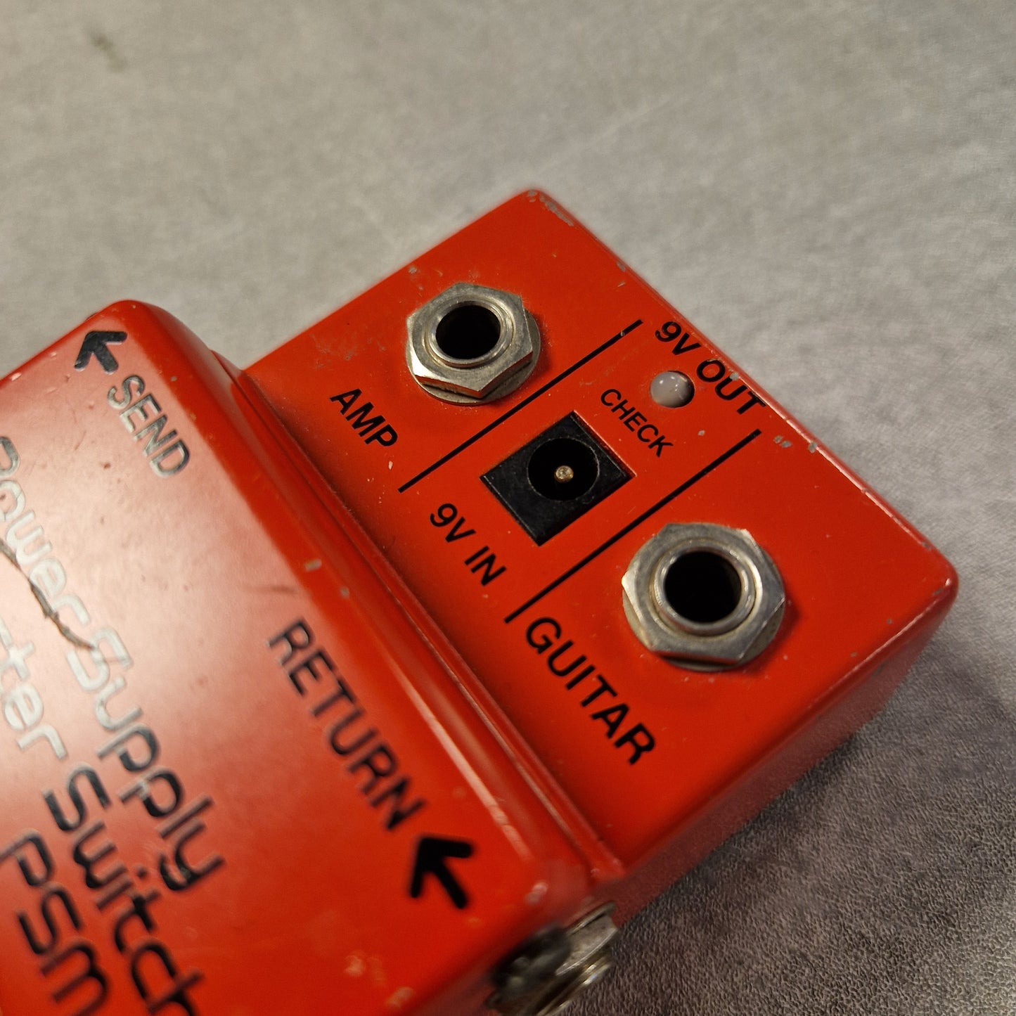Pre-Owned Boss PSM-5 Red electrical connector with labeled ports on a gray background