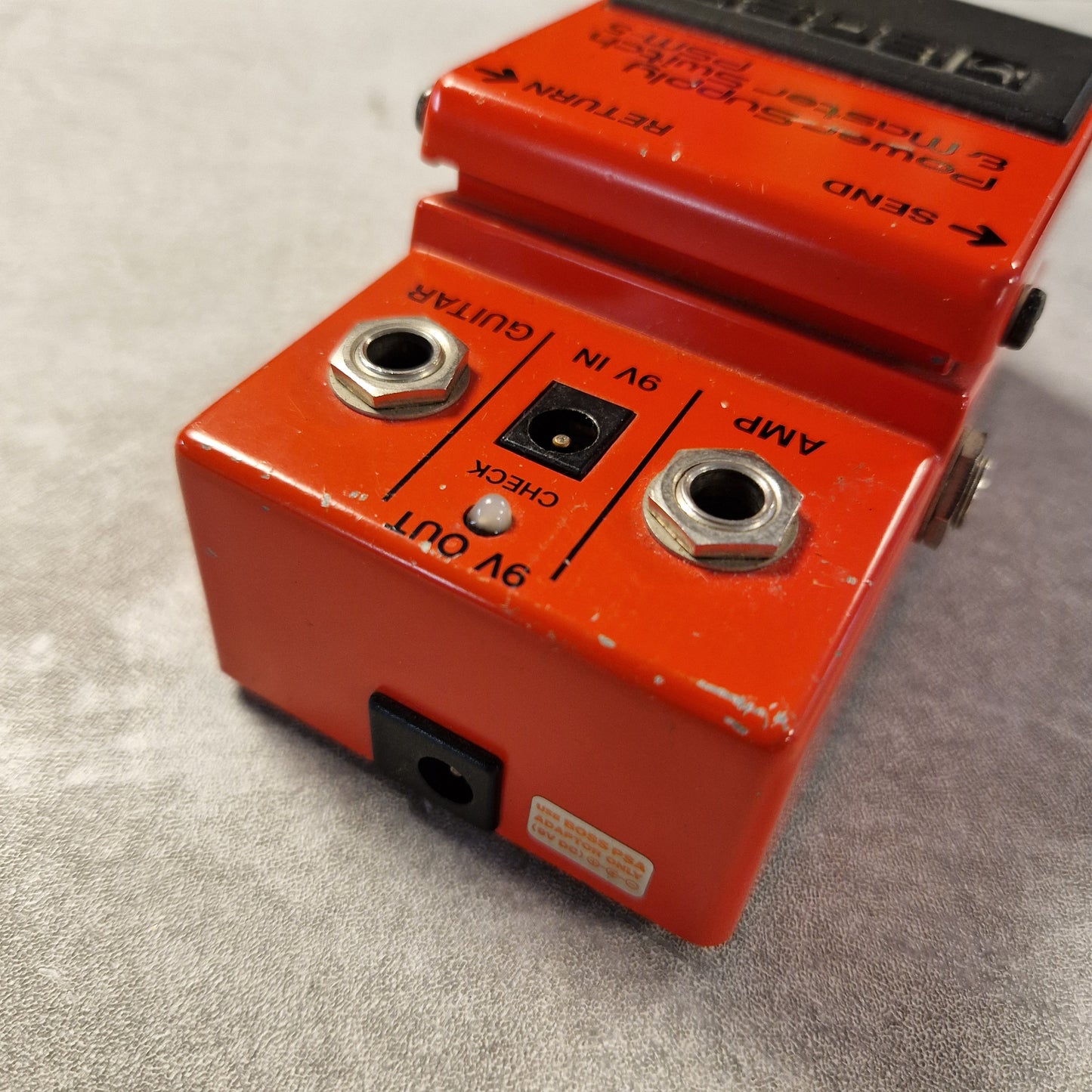 Pre-Owned Boss PSM-5 Red guitar effects pedal with visible branding on a gray surface