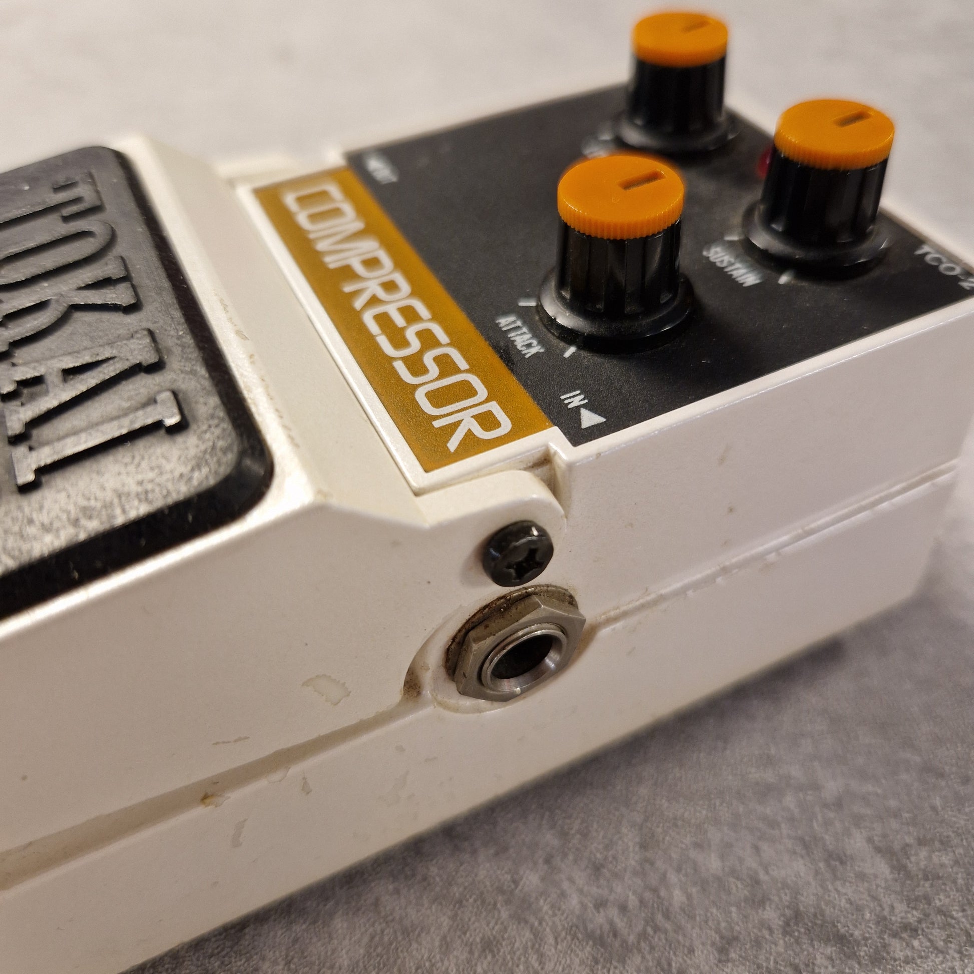 Pre-Owned Tokai Z-II TCO-2 Close-up of a Tokai compressor pedal with visible branding on a gray background