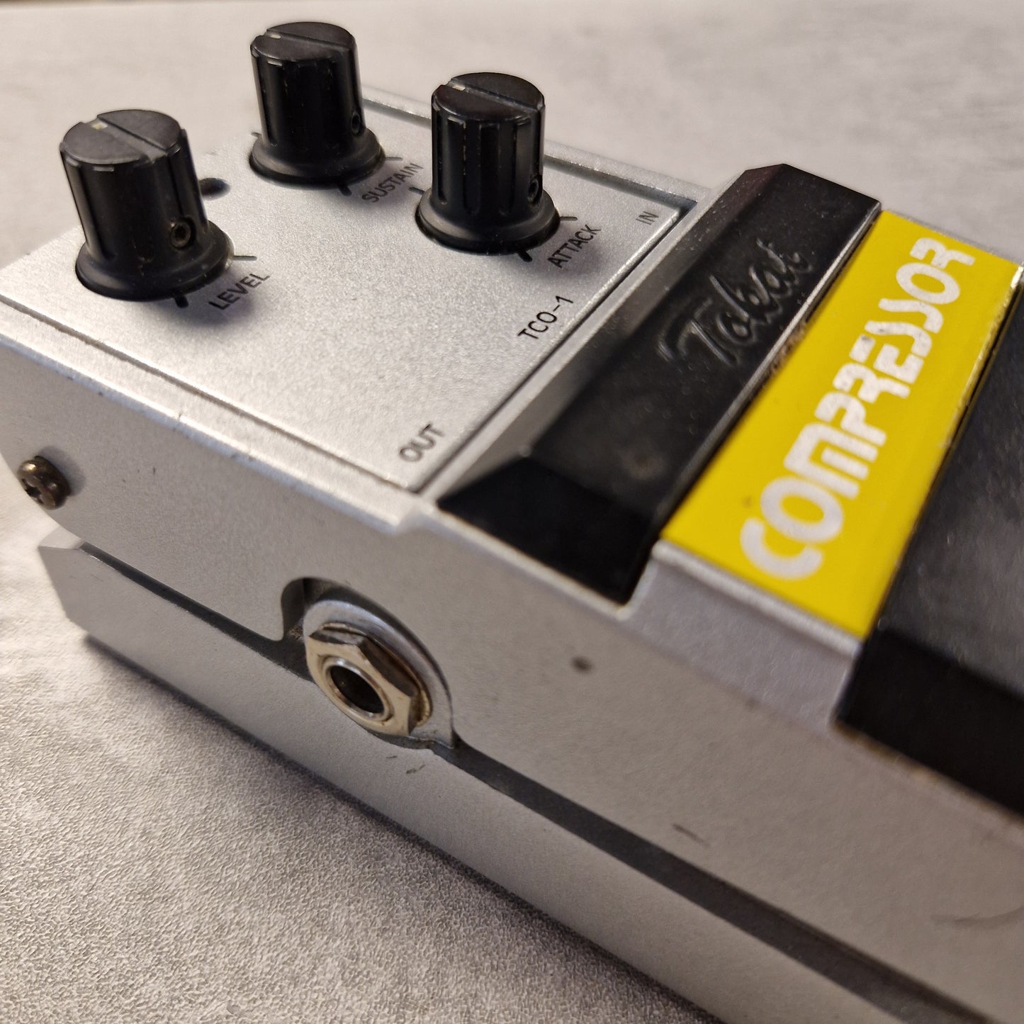 Pre-Owned Tokai TCO-1 Close-up of a guitar effects pedal with 'Compaq' branding on a gray surface