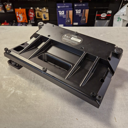 Pre-Owned Line 6 POD Go Black metal bracket on a gray surface with a blurred background