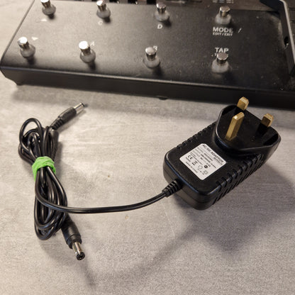 Pre-Owned Line 6 POD Go Power adapter with plug and cable on a textured surface