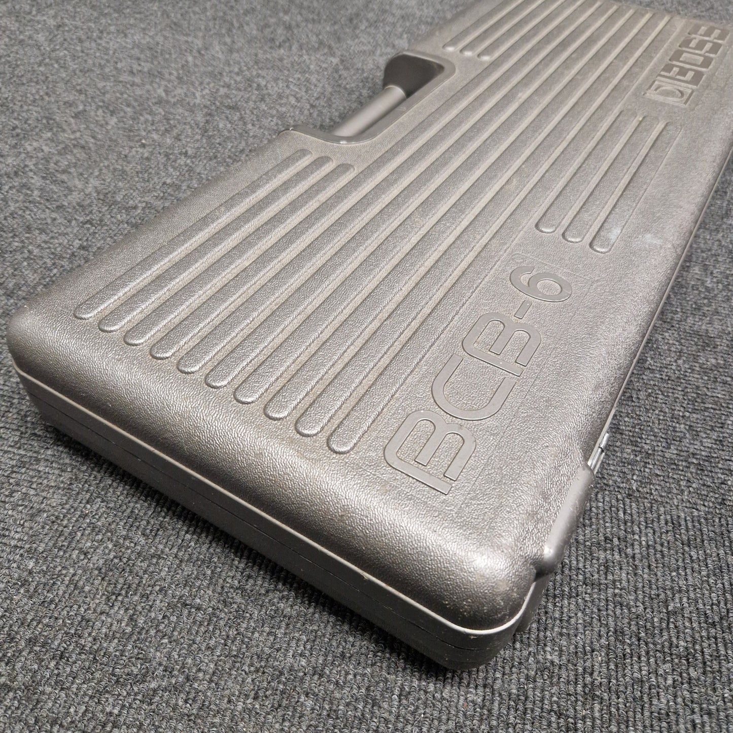 Pre-Owned Boss BCB-6 Metallic foot pedal on a textured gray surface