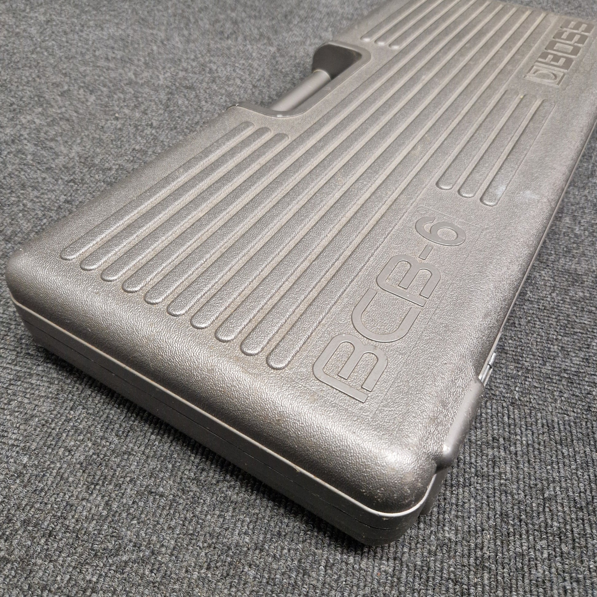 Pre-Owned Boss BCB-6 Metallic foot pedal on a textured gray surface