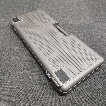 Pre-Owned Boss BCB-6 Silver metallic case on a textured gray surface