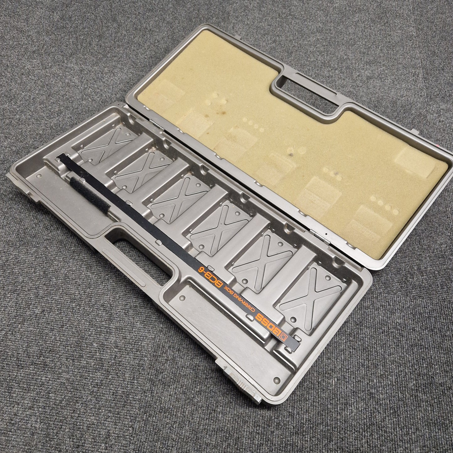 Pre-Owned Boss BCB-6 Metallic tool case with compartments on a gray textured background