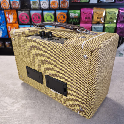 Pre-Owned Kala AMP-TWD Beige guitar amplifier on a gray surface with colorful boxes in the background