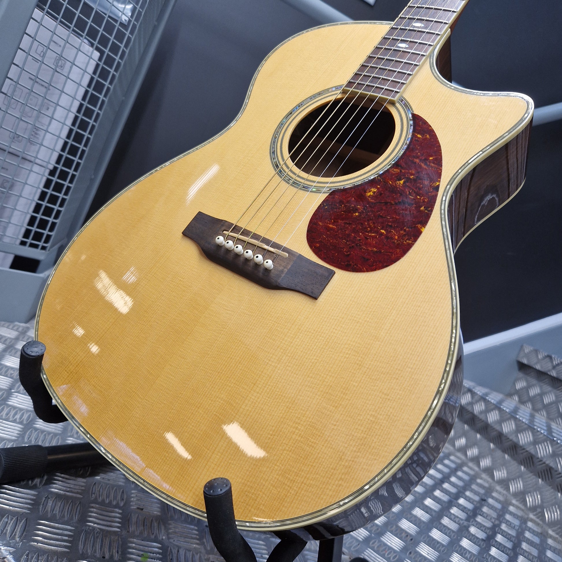 Pre-Owned Crafter TMC035/N Acoustic guitar on a stand with a blurred background