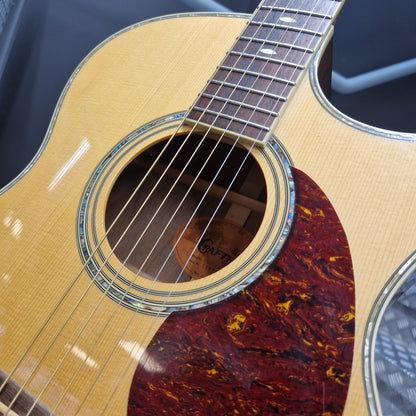 Pre-Owned Crafter TMC035/N Close-up of an acoustic guitar with a focus on the soundhole and neck.
