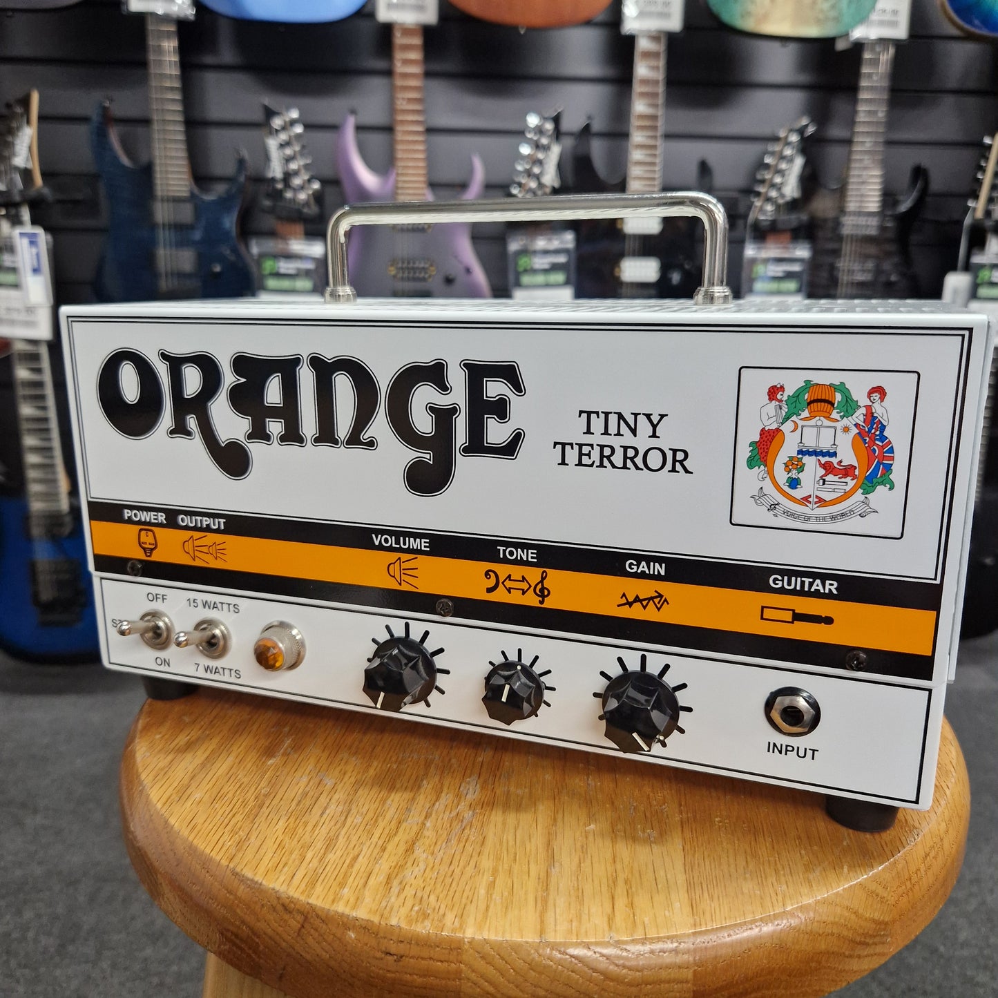 Pre-Owned Orange TT15H Orange Tiny Terror guitar effects pedal with guitars in the background