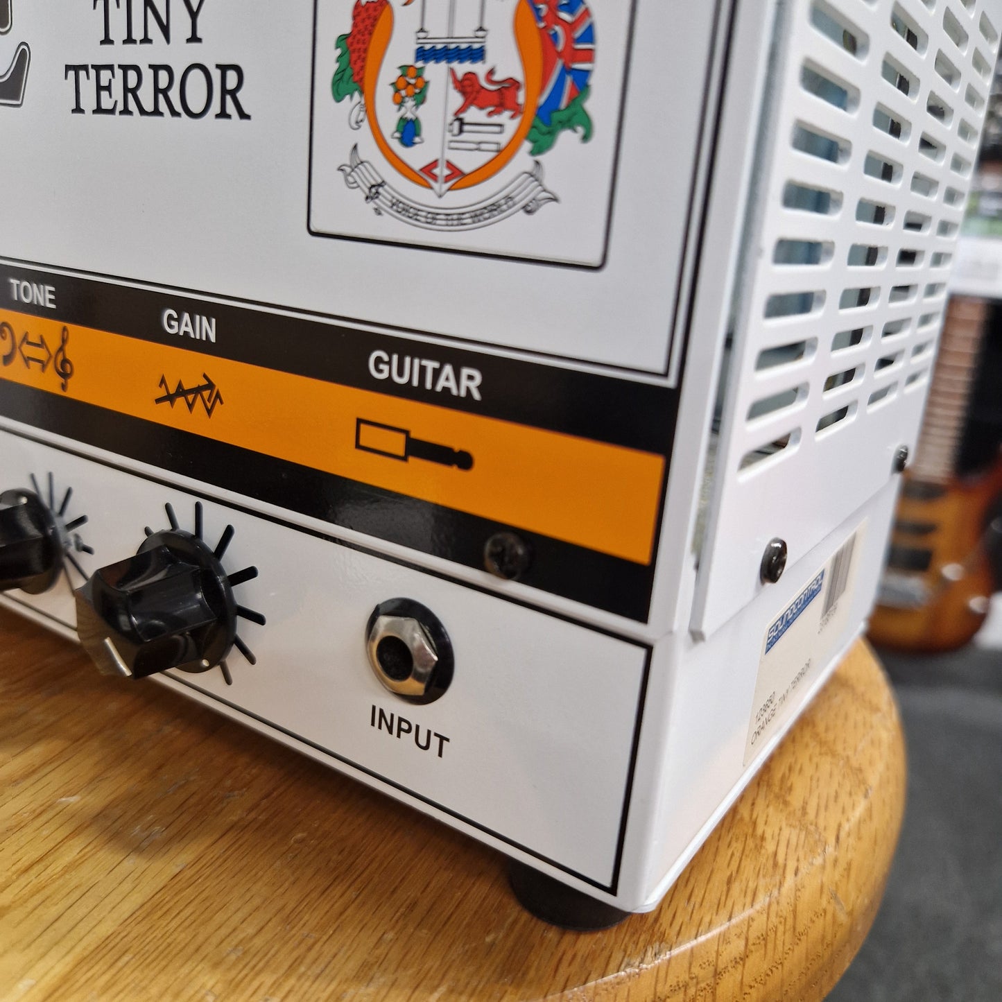 Pre-Owned Orange TT15H Guitar amplifier with 'Tiny Terror' branding on a wooden surface