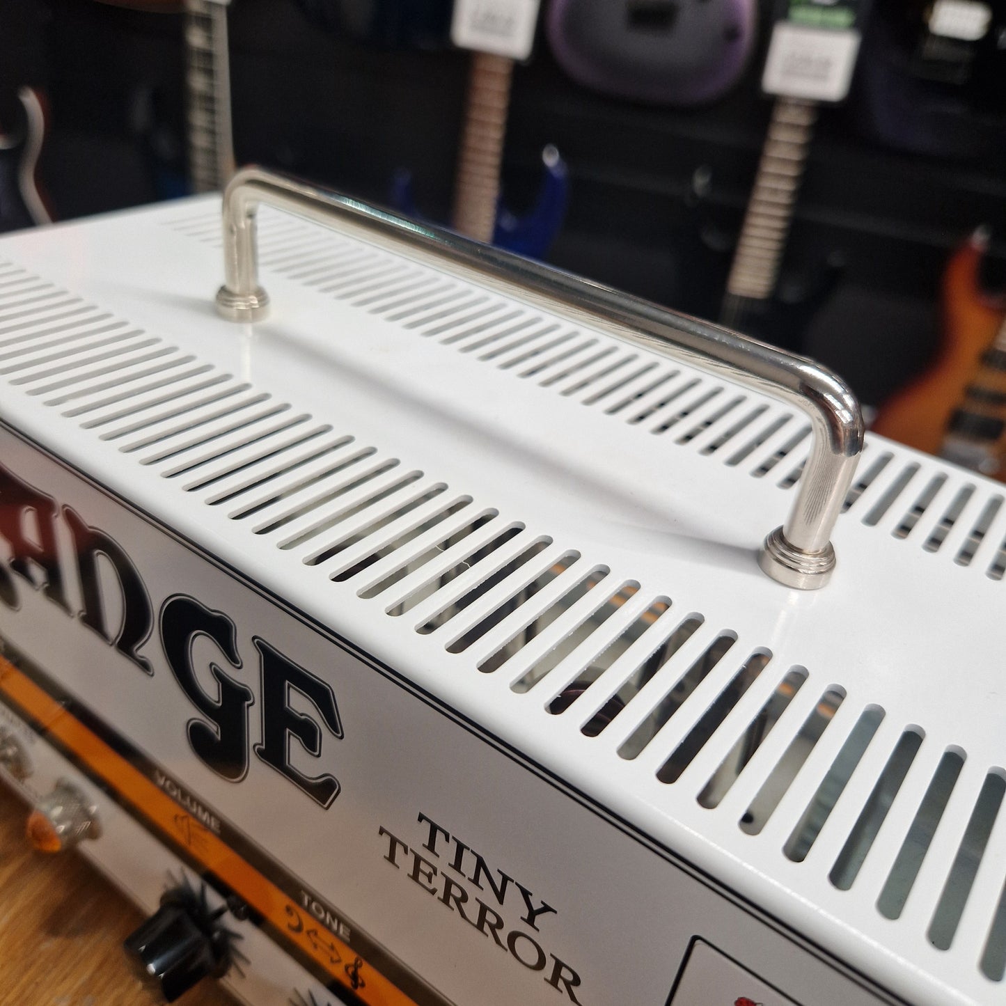 Pre-Owned Orange TT15H Fender guitar amplifier with 'Tiny Terror' model name in a music store setting