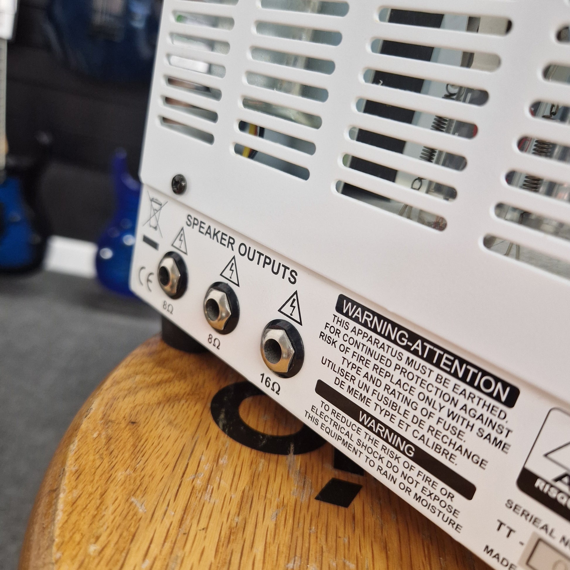 Pre-Owned Orange TT15H Close-up of electronic component with warning labels on a wooden surface