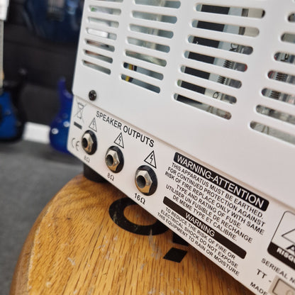 Pre-Owned Orange TT15H Close-up of electronic component with warning labels on a wooden surface