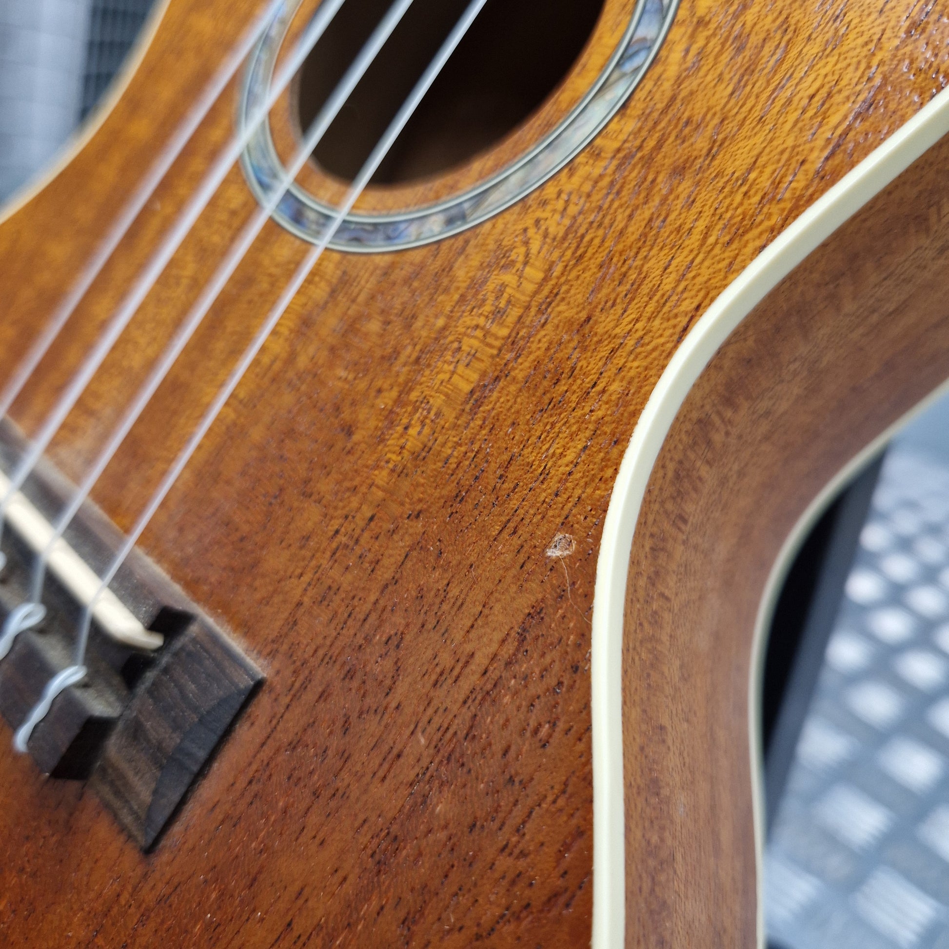 Pre-Owned Cordoba 15CM Close-up of a wooden ukulele with a blurred background