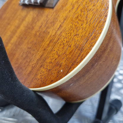 Pre-Owned Cordoba 15CM Close-up of a wooden guitar body with a blurred background