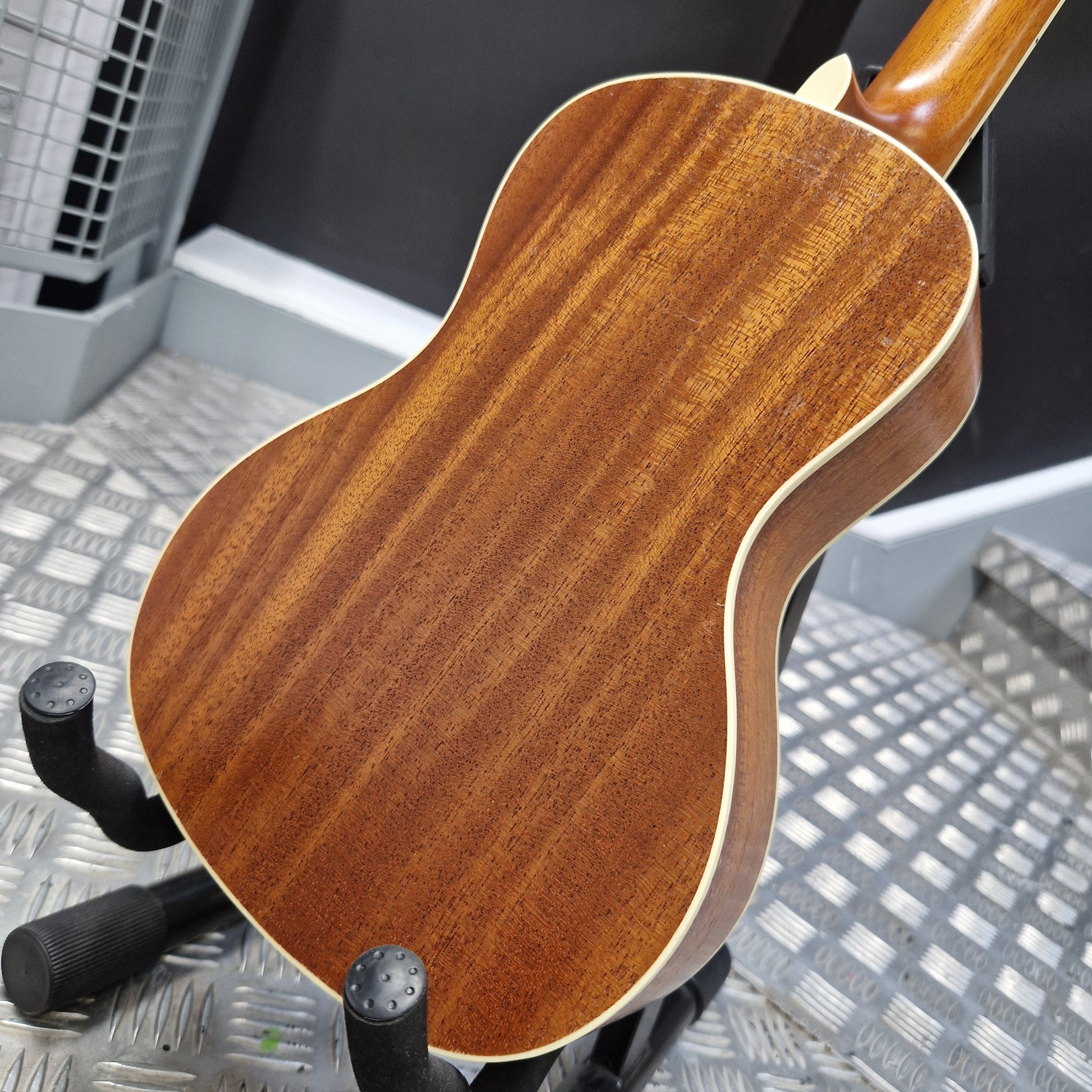 Pre-Owned Cordoba 15CM Close-up of a wooden acoustic guitar on a stand with a blurred background