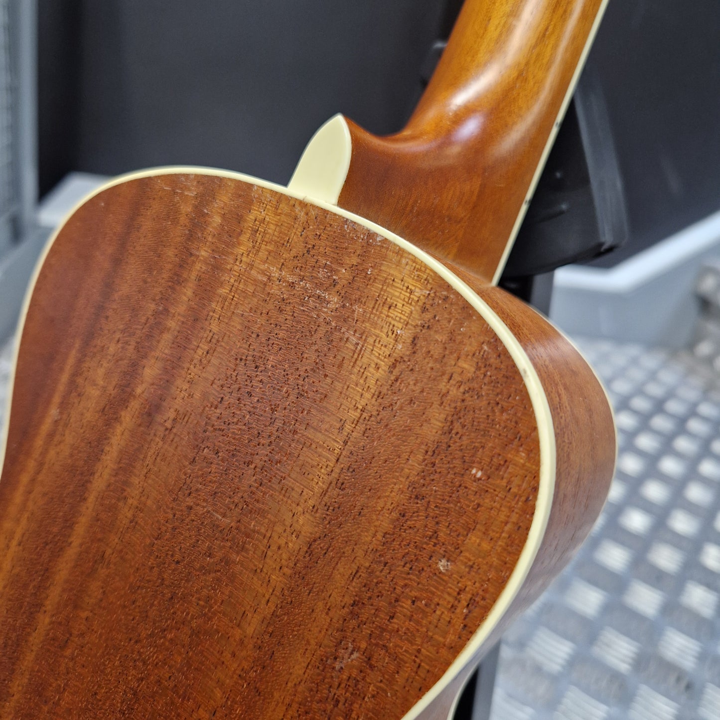 Pre-Owned Cordoba 15CM Close-up of a wooden guitar neck with a blurred background