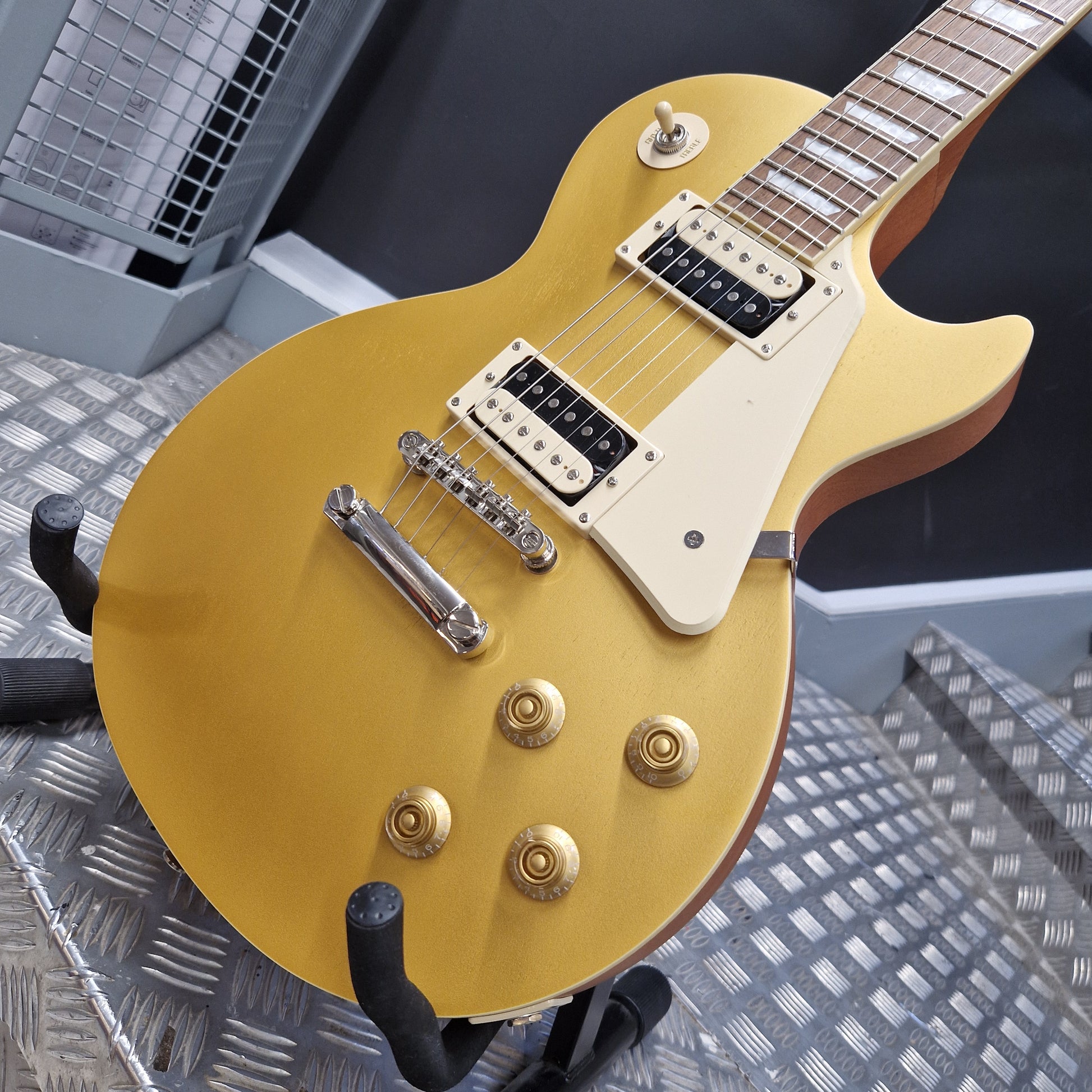Pre-Owned Epiphone Les Paul Gold electric guitar on a metallic surface